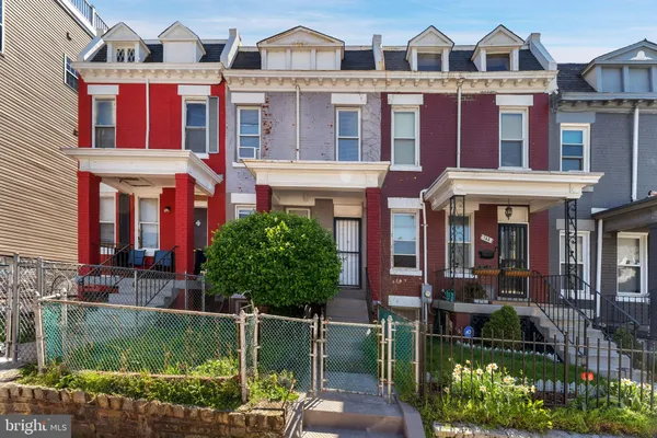 front view of residential houses with a yard