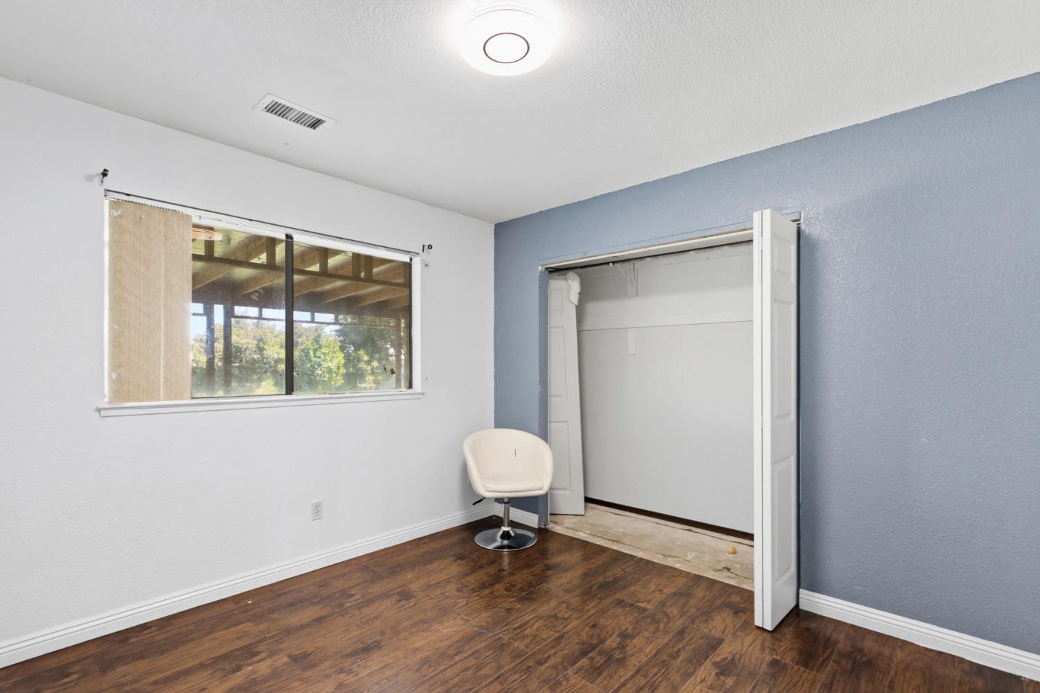 7208 7th Street Rio Linda, CA 95673 - Photo 19 of 41 a view of a room with a large window and wooden floor