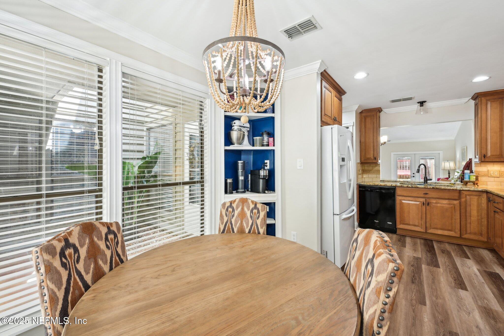585 Pine Forest Trail Orange Park, FL 32073 - Photo 12 of 52 a bedroom with a bed and a chandelier
