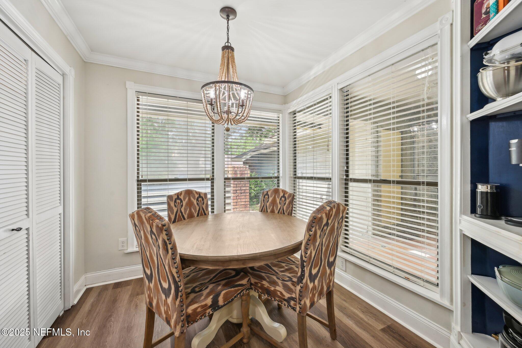 585 Pine Forest Trail Orange Park, FL 32073 - Photo 13 of 52 a view of a dining room with furniture window and wooden floor