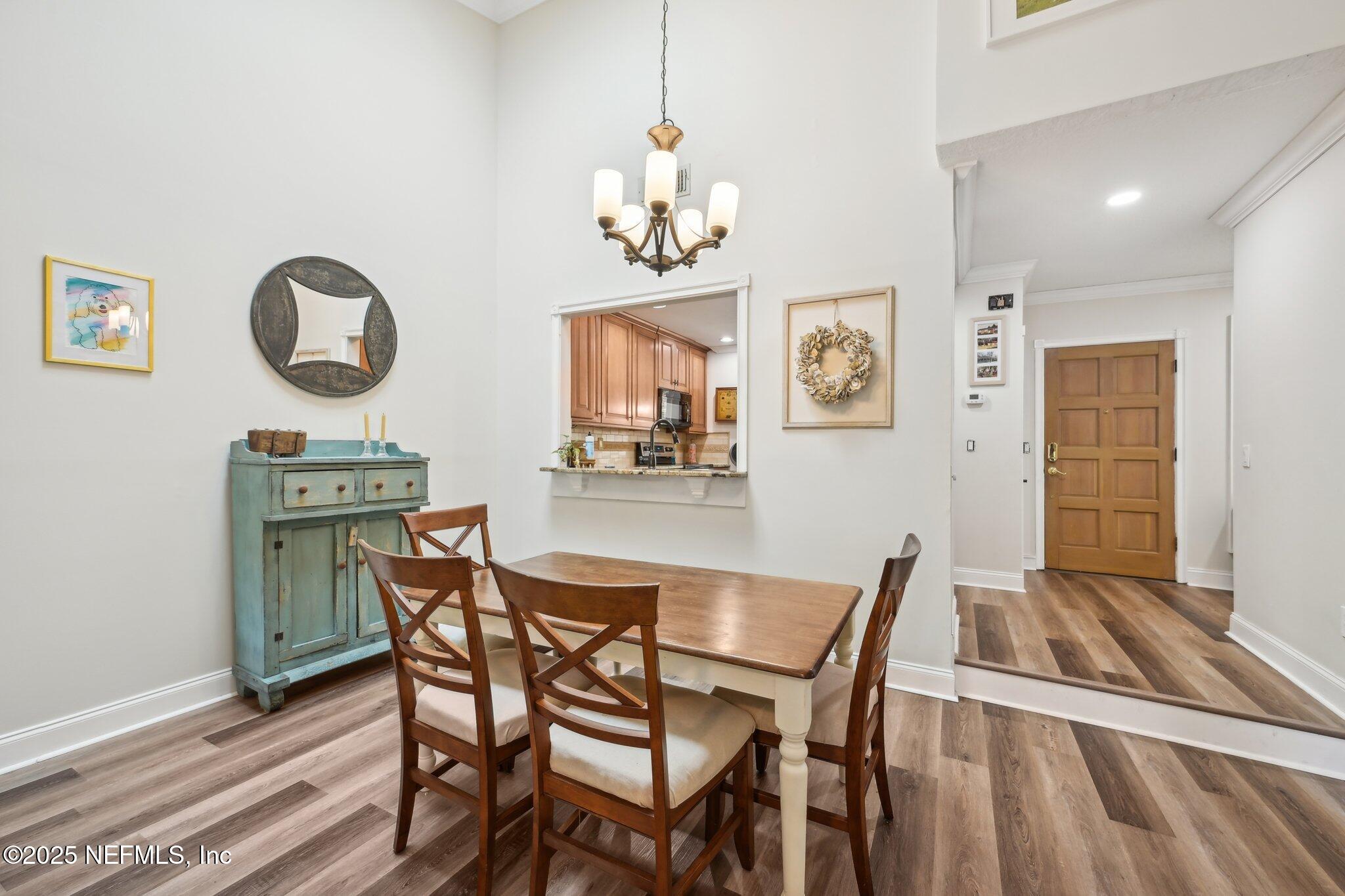 585 Pine Forest Trail Orange Park, FL 32073 - Photo 14 of 52 a dining room with wooden floor and a chandelier