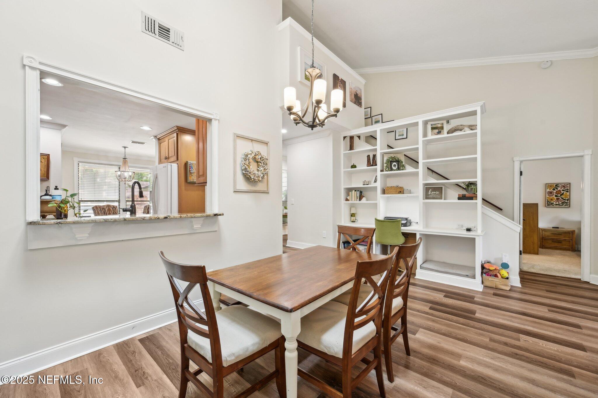 585 Pine Forest Trail Orange Park, FL 32073 - Photo 15 of 52 a view of a dining room with furniture and wooden floor