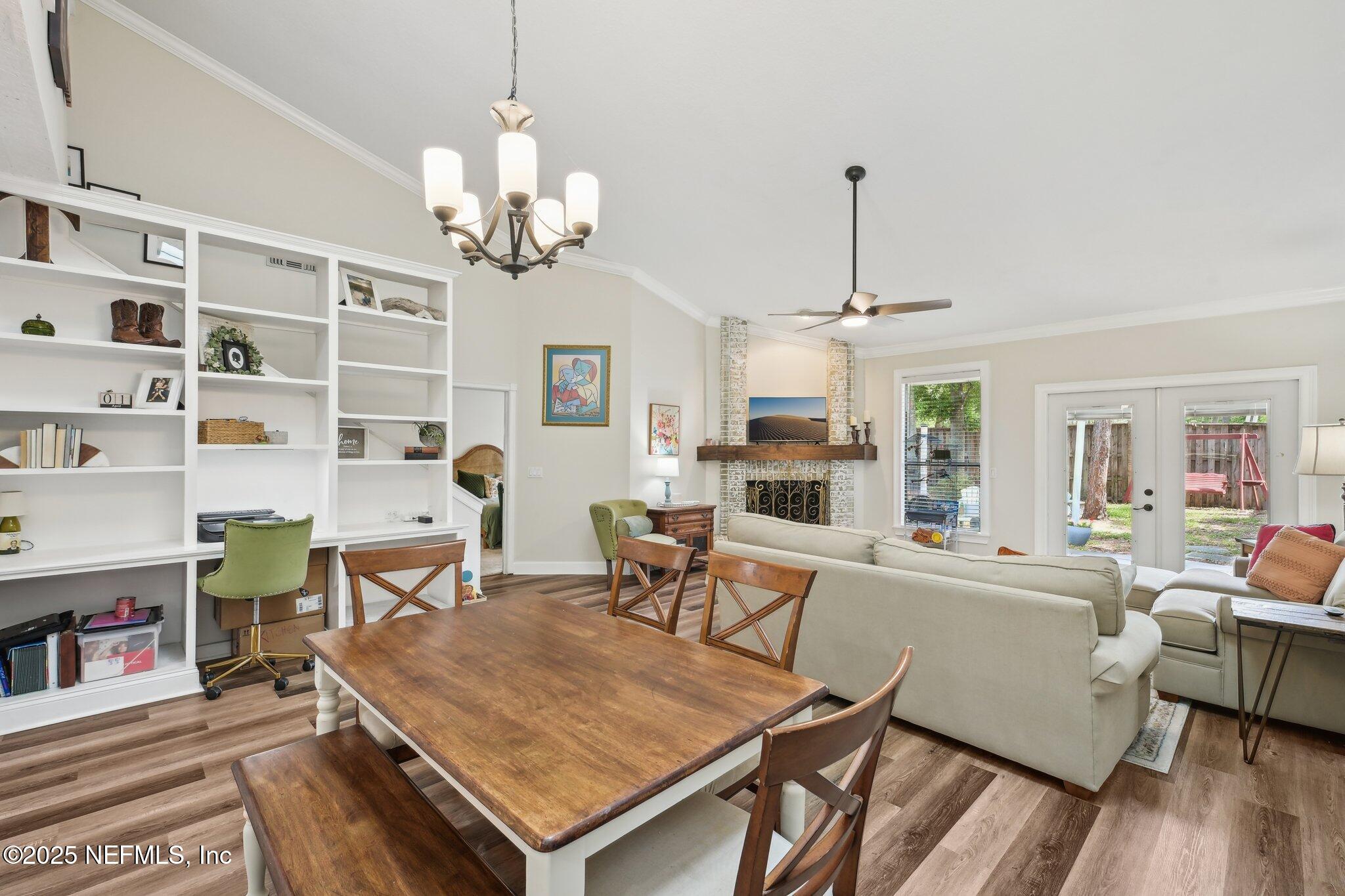 585 Pine Forest Trail Orange Park, FL 32073 - Photo 16 of 52 a living room with furniture a dining table and a chandelier