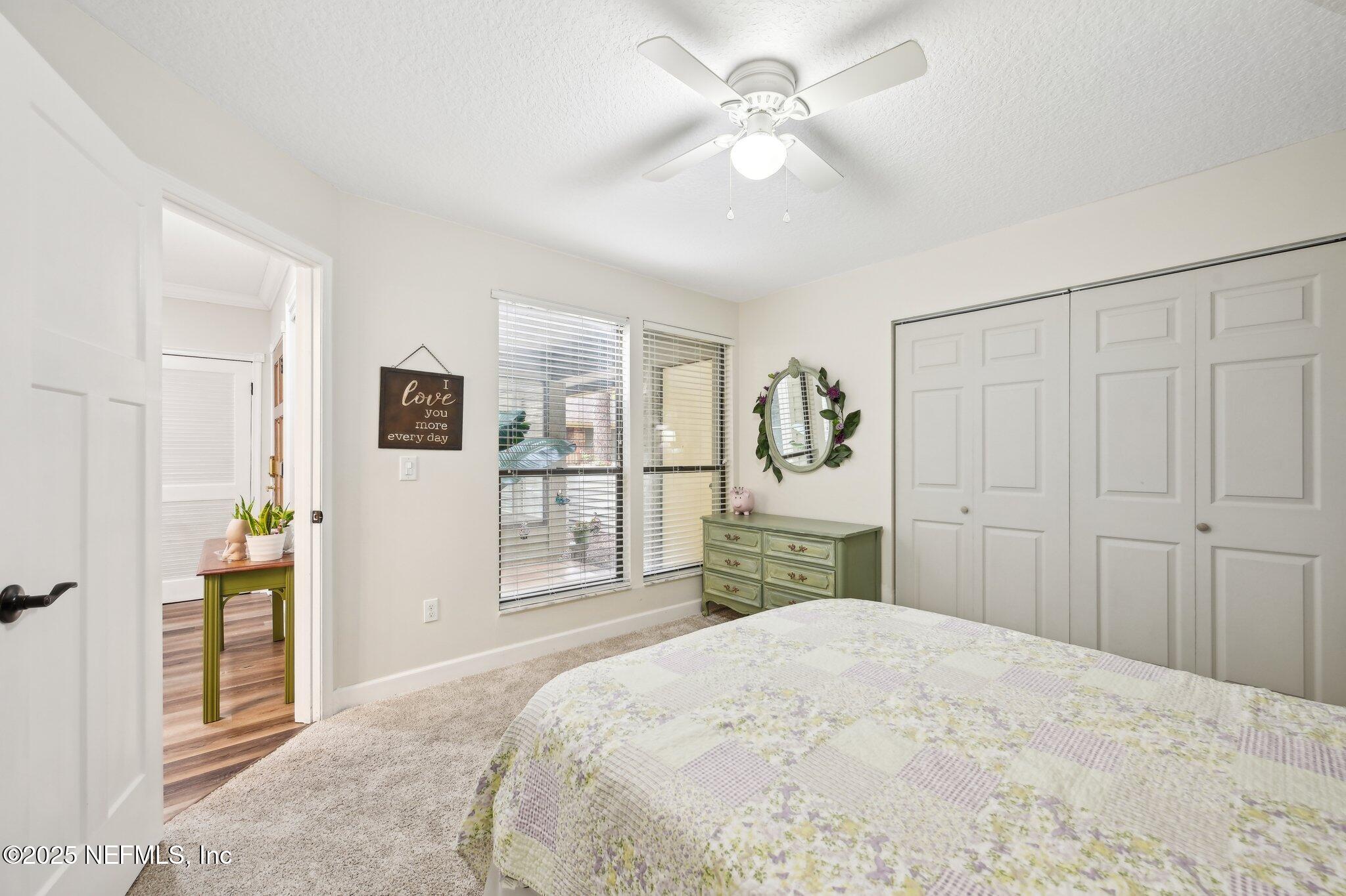 585 Pine Forest Trail Orange Park, FL 32073 - Photo 23 of 52 a bedroom with a large bed a chandelier and closet