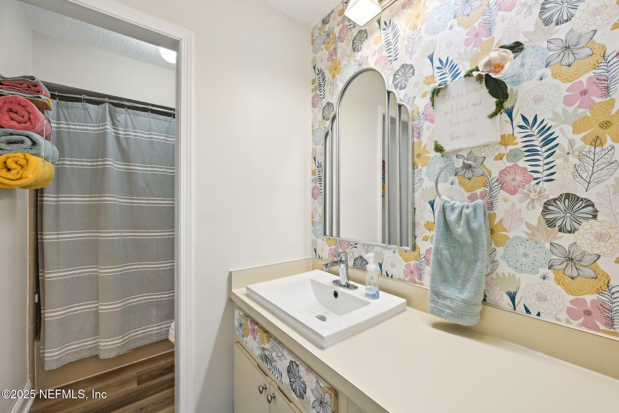 585 Pine Forest Trail Orange Park, FL 32073 - Photo 31 of 52 a bathroom with a sink mirror and vanity
