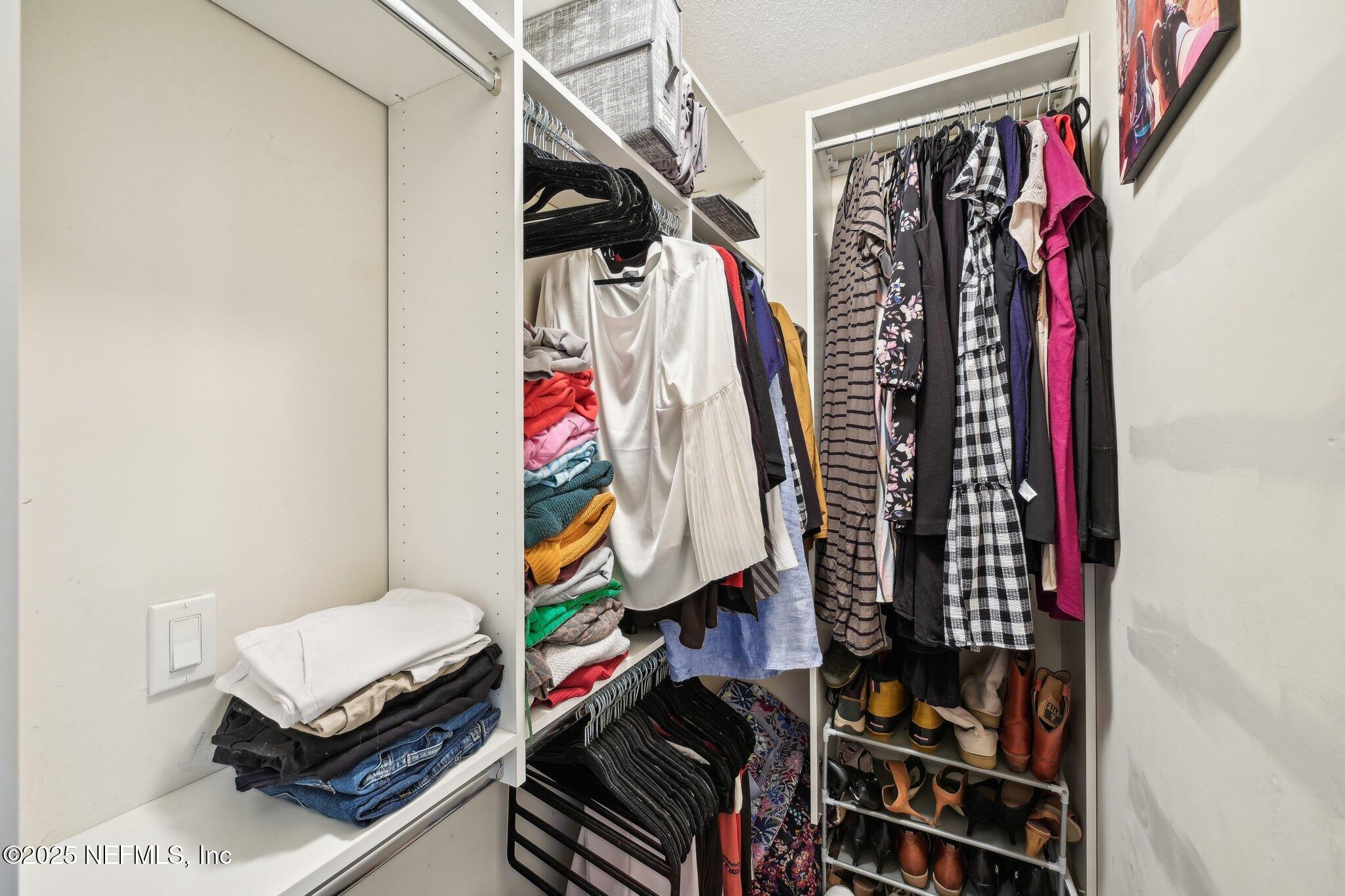 585 Pine Forest Trail Orange Park, FL 32073 - Photo 35 of 52 a view of walk in closet with clothes and shoes