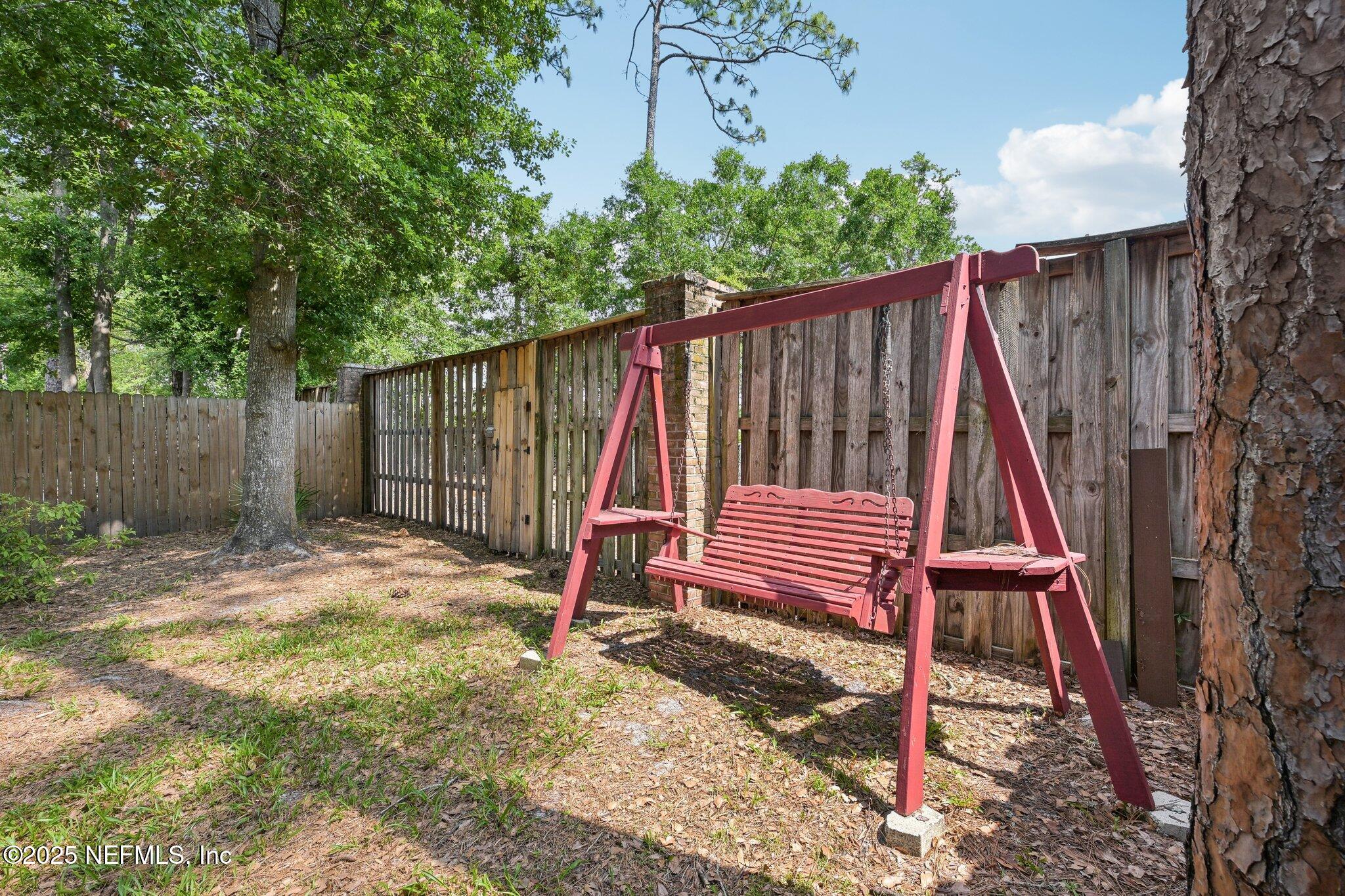 585 Pine Forest Trail Orange Park, FL 32073 - Photo 39 of 52 a backyard of a house with table and chairs