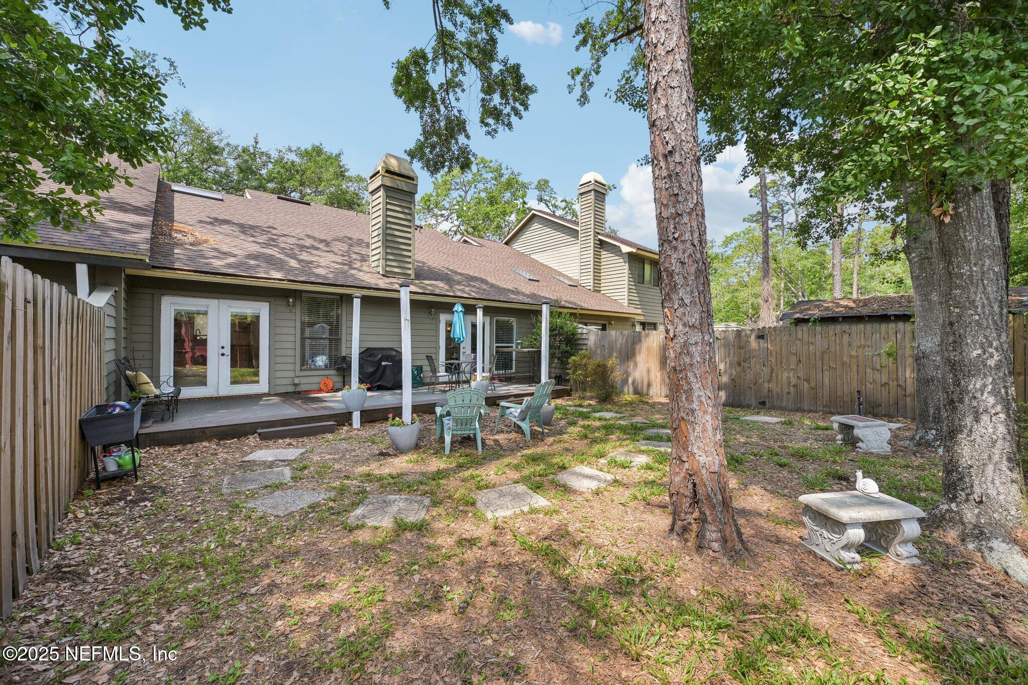 585 Pine Forest Trail Orange Park, FL 32073 - Photo 40 of 52 a front view of a house with garden and patio