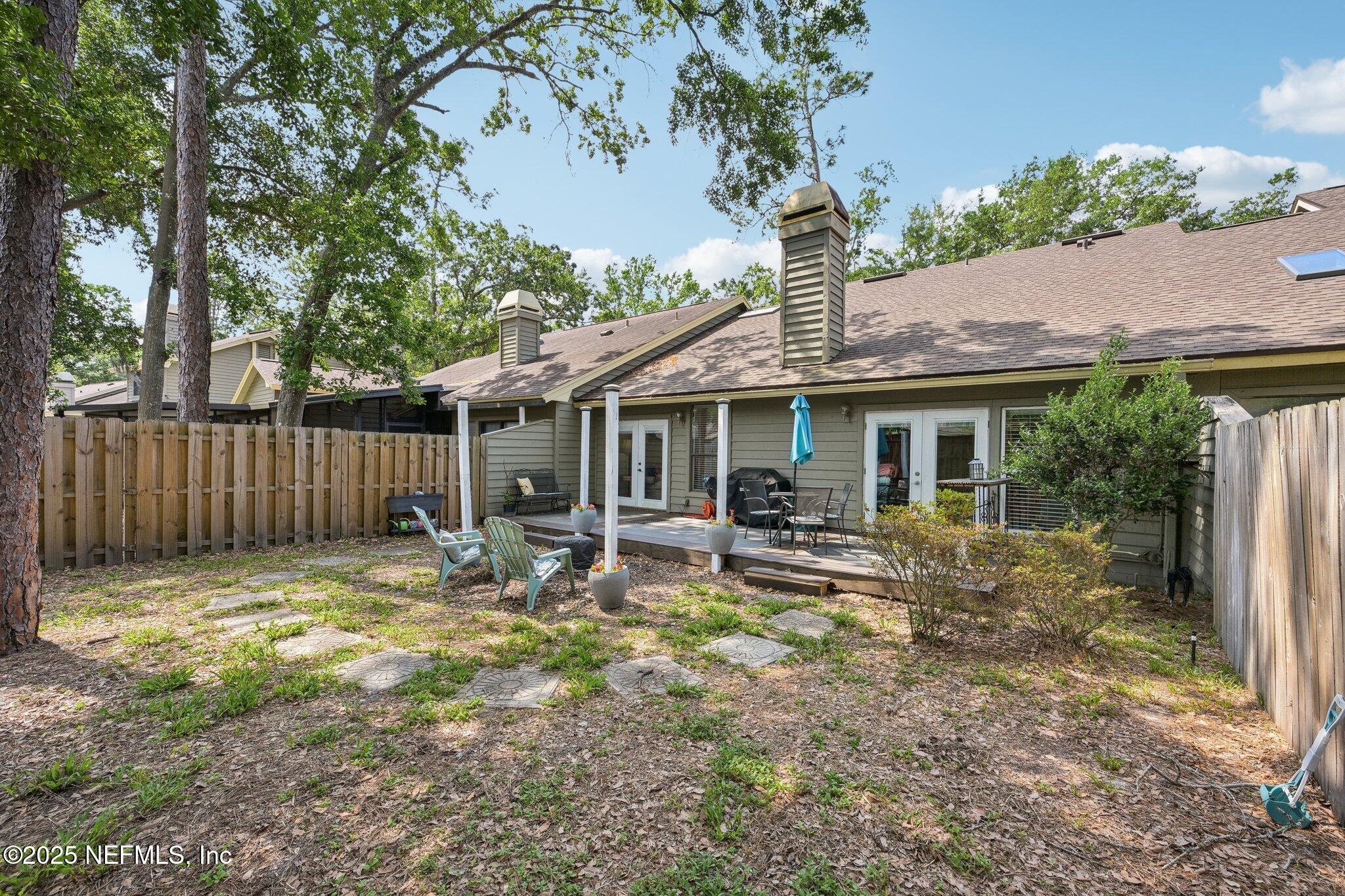 585 Pine Forest Trail Orange Park, FL 32073 - Photo 42 of 52 a backyard of a house with table and chairs