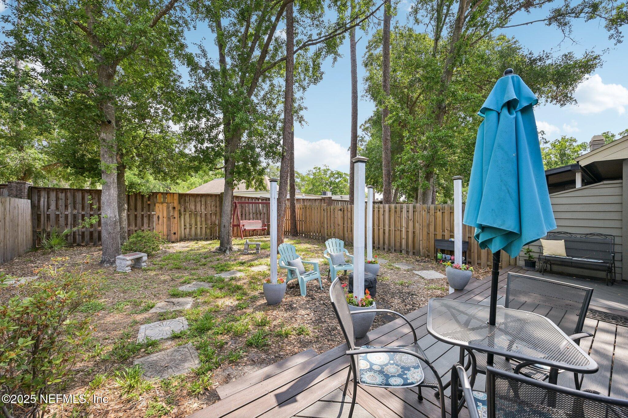 585 Pine Forest Trail Orange Park, FL 32073 - Photo 43 of 52 a view of backyard with a table and chairs