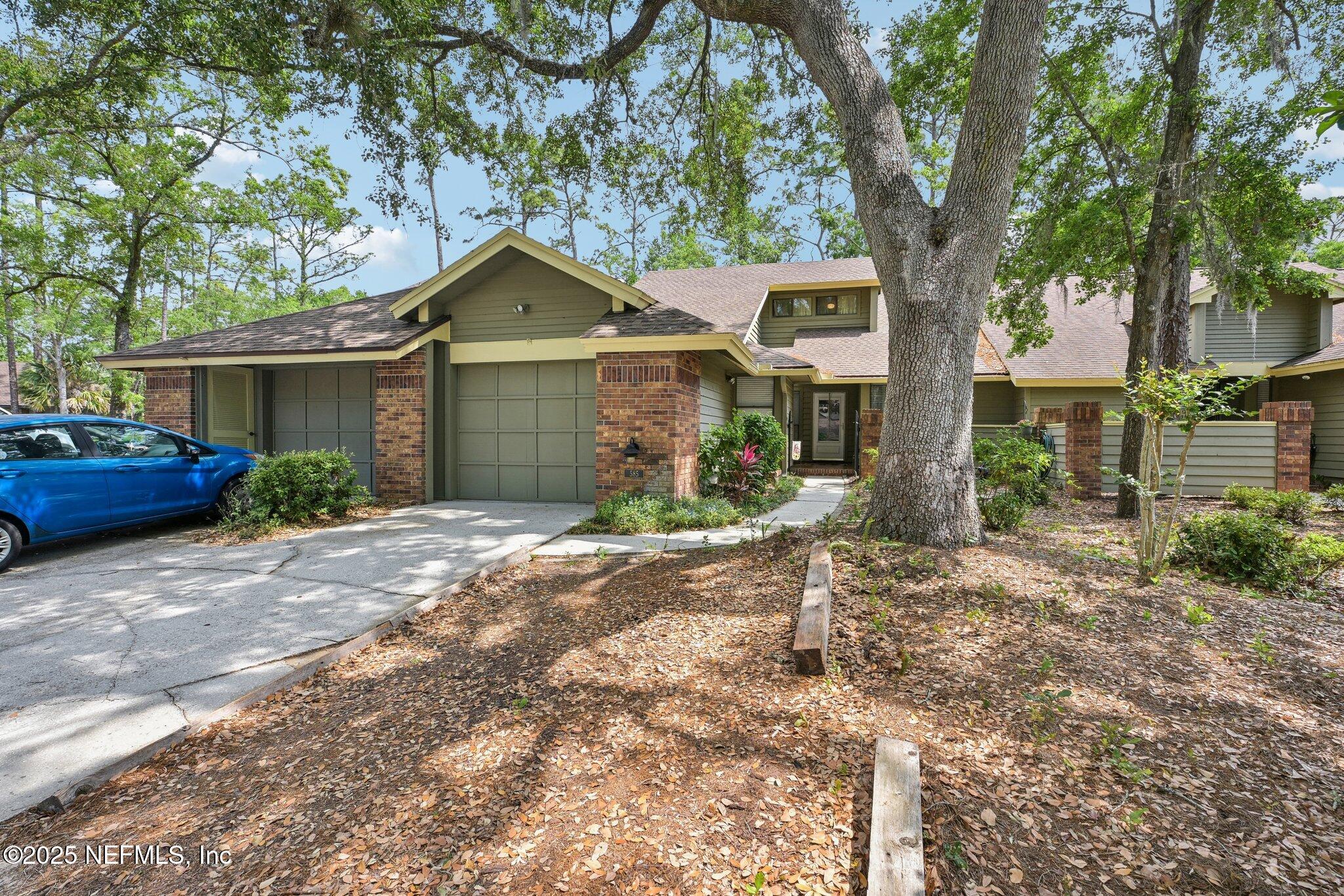 585 Pine Forest Trail Orange Park, FL 32073 - Photo 5 of 52 a front view of a house with a yard and a large tree