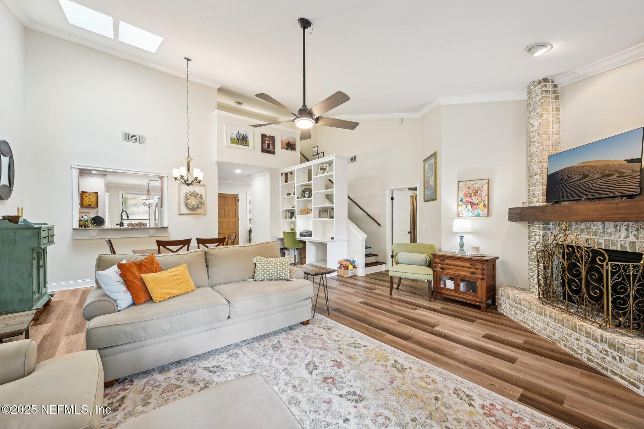 585 Pine Forest Trail Orange Park, FL 32073 - Photo 10 of 52 a living room with furniture a fireplace and a flat screen tv