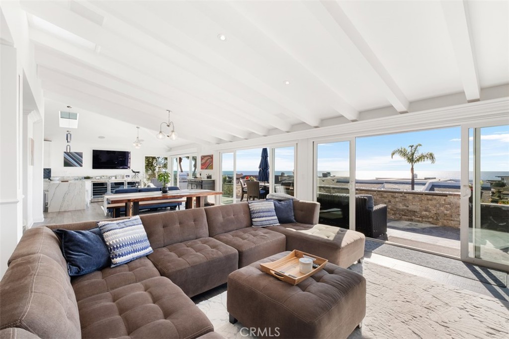 33675 Magellan Dana Point, CA 92629 - Photo 11 of 43 a living room with furniture white walls and kitchen view
