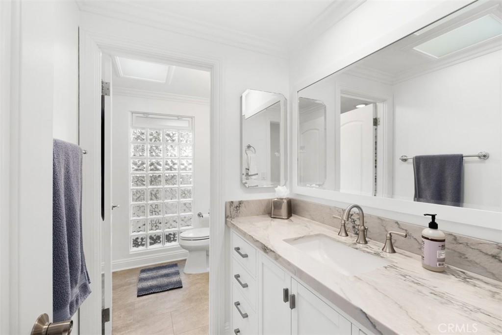 33675 Magellan Dana Point, CA 92629 - Photo 25 of 43 a bathroom with double vanity sinks a mirror and a shower