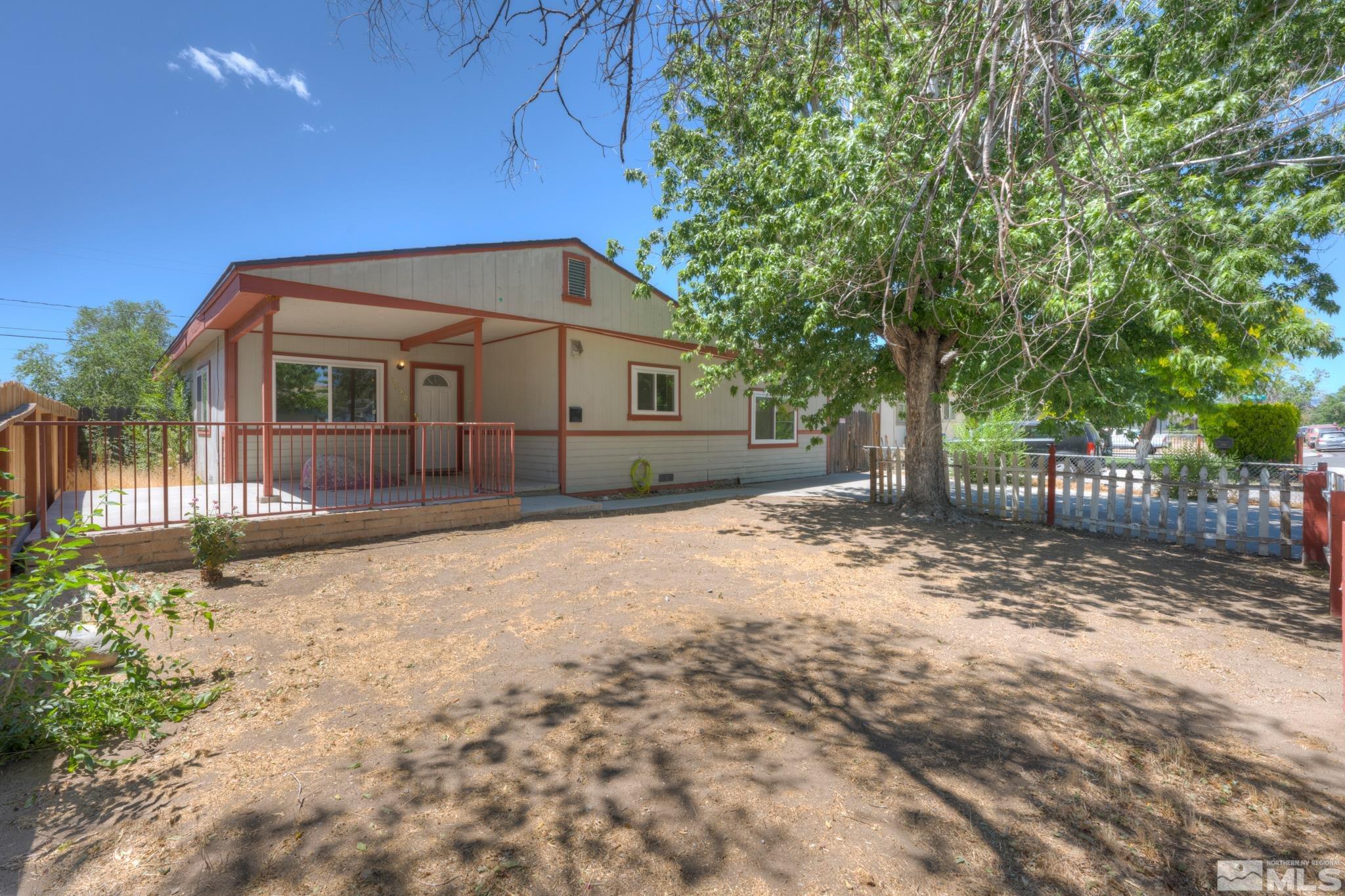 1890 Trainer Way Reno, NV 89512 - Photo 1 of 19 a front view of a house with a yard and garage