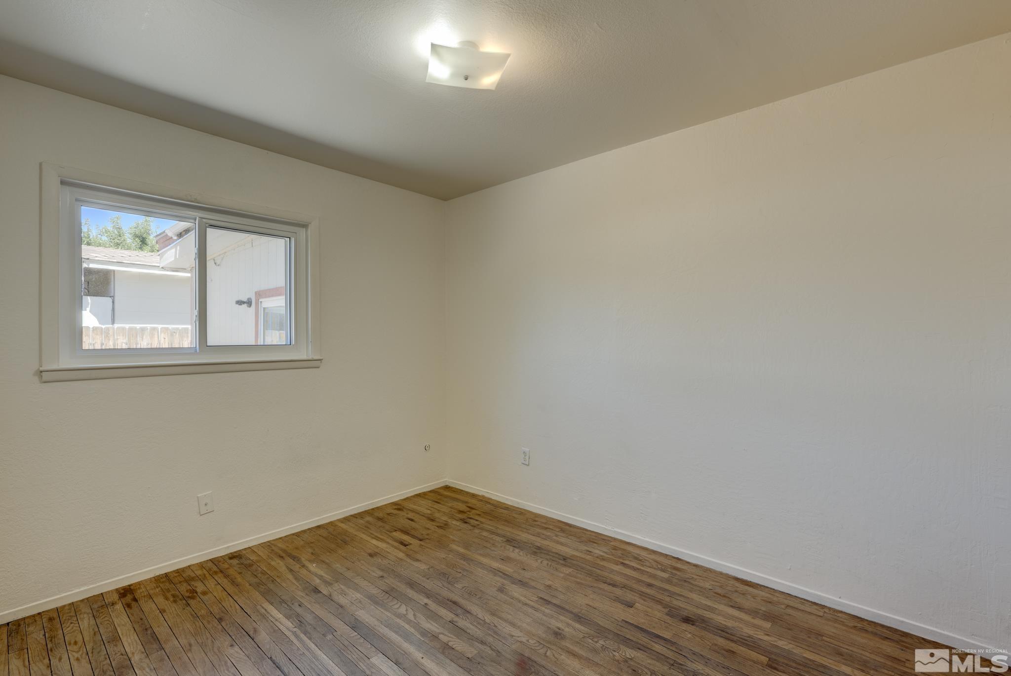 1890 Trainer Way Reno, NV 89512 - Photo 11 of 19 a view of empty room with wooden floor and fan