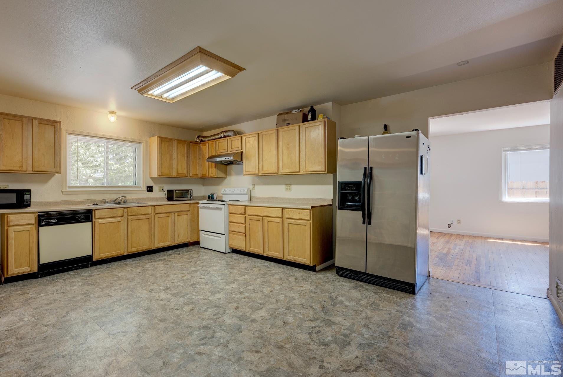 1890 Trainer Way Reno, NV 89512 - Photo 16 of 19 a kitchen with stainless steel appliances a refrigerator sink and cabinets