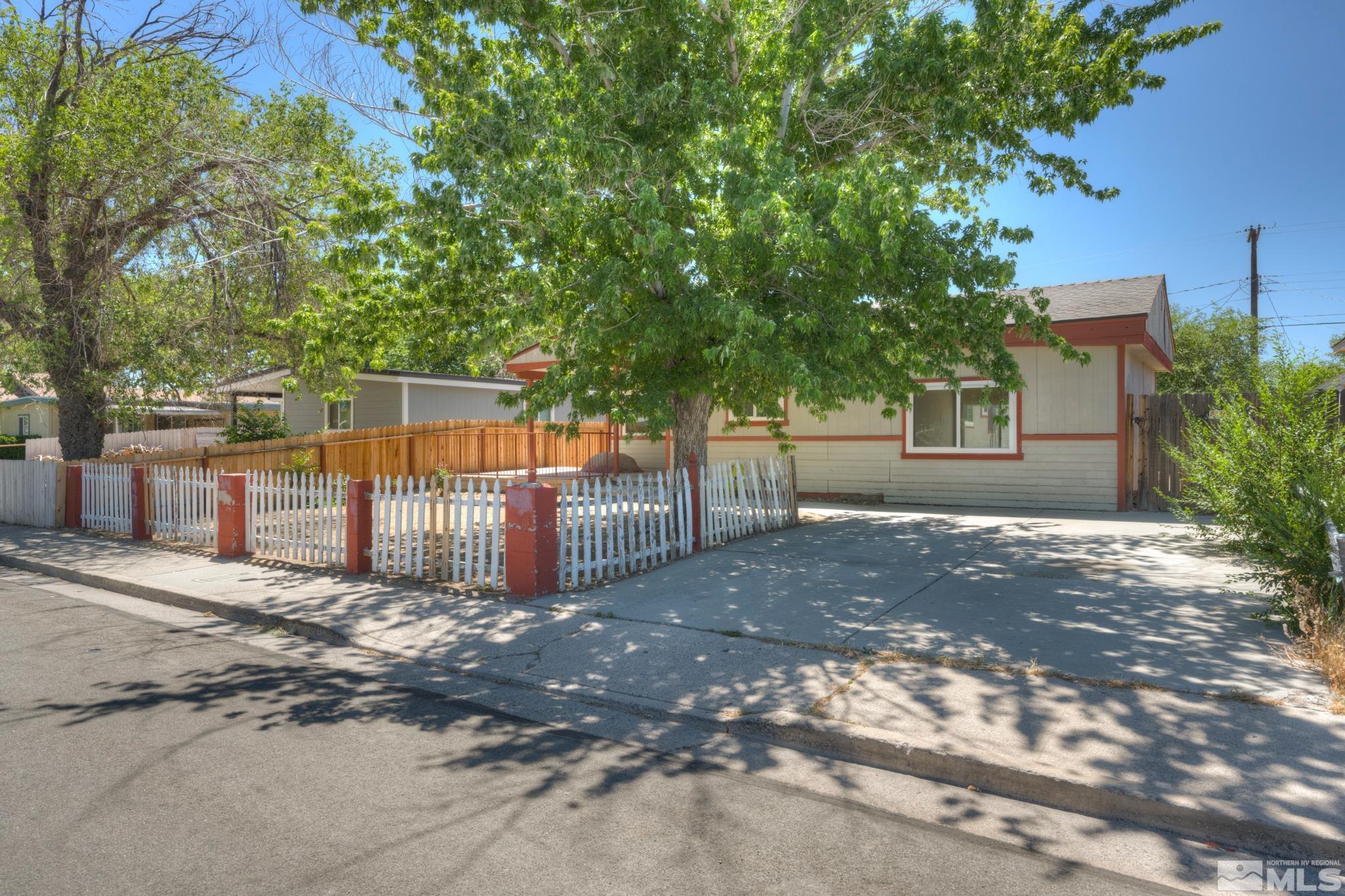 1890 Trainer Way Reno, NV 89512 - Photo 3 of 19 a view of a backyard with large trees and a small barn