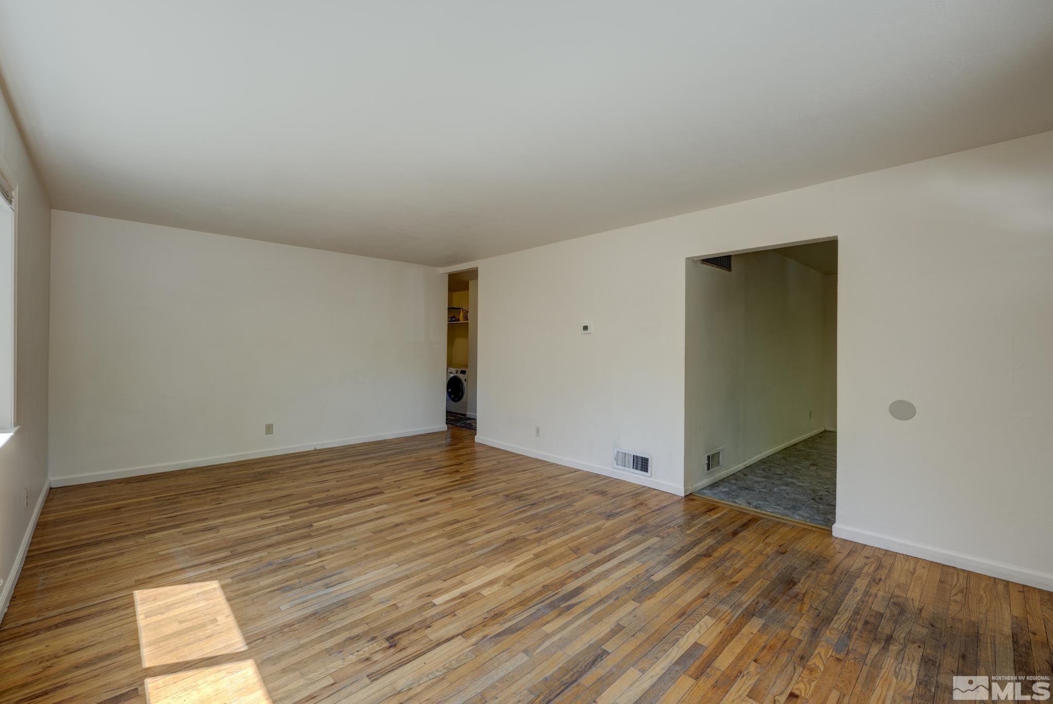 1890 Trainer Way Reno, NV 89512 - Photo 6 of 19 a view of an empty room and wooden floor