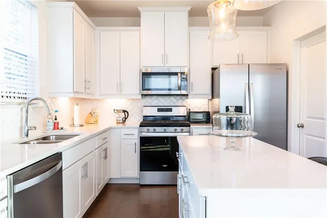 a kitchen with a sink stove and refrigerator
