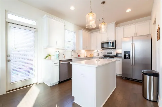 a kitchen with a refrigerator a microwave and cabinets