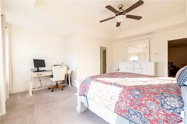 a bedroom with a bed and a desk