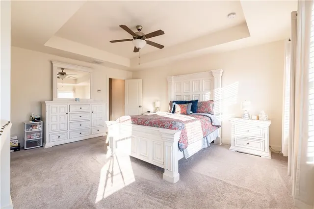 a bed room with a bed and a ceiling fan