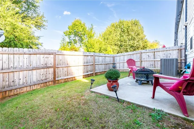 a view of a chair and table in backyard