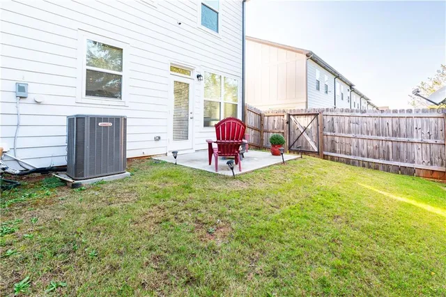 a view of a backyard with brick wall and a table and chair