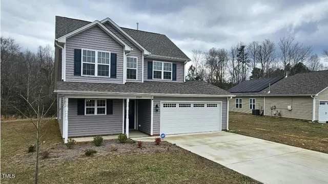 a front view of a house with garage