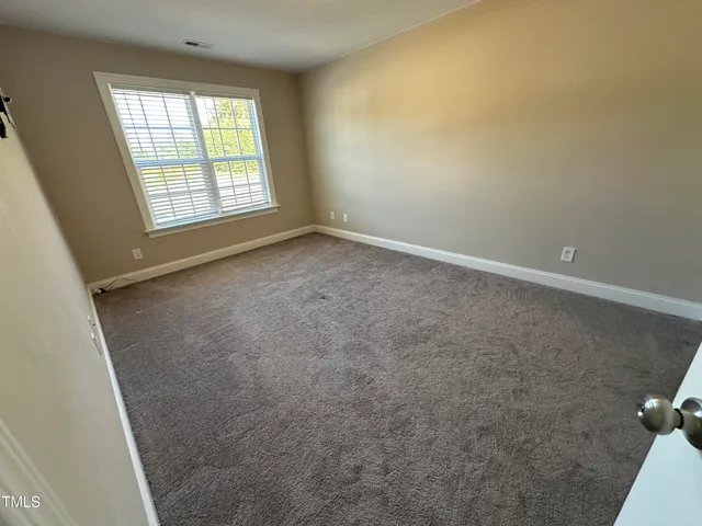 an empty room with a empty space and windows