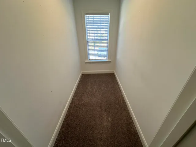 a view of a hallway with a window