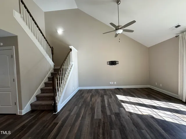 a view of a room with wooden floor and white walls