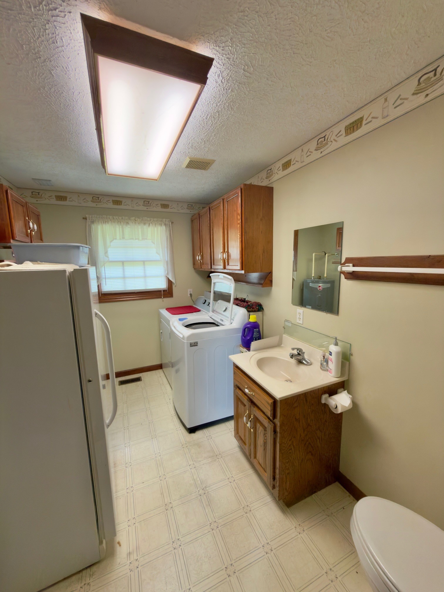 4929 Fountain Grove Road Morrison, TN 37357 - Photo 25 of 33 a room with a sink a window and a painting on the wall