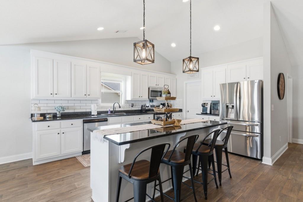 844 River Mist Circle Jefferson, GA 30549 - Photo 11 of 35 a kitchen with stainless steel appliances a stove a sink island and a refrigerator