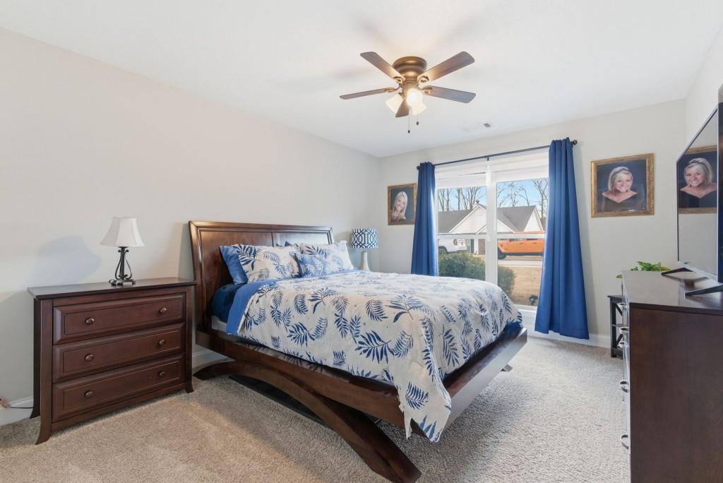 844 River Mist Circle Jefferson, GA 30549 - Photo 20 of 35 a bedroom with a bed and a chandelier