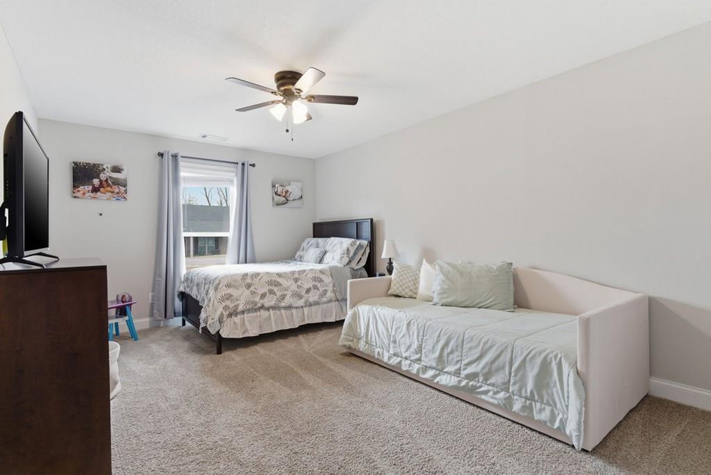 844 River Mist Circle Jefferson, GA 30549 - Photo 21 of 35 a bedroom with a bed and a couch