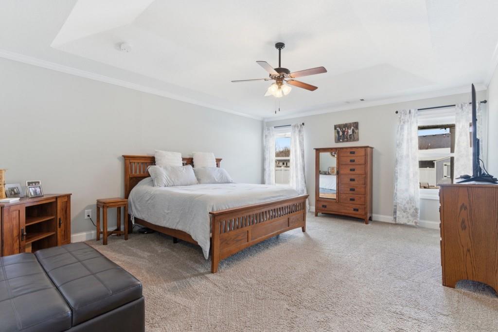 844 River Mist Circle Jefferson, GA 30549 - Photo 25 of 35 a bedroom with a bed and a chandelier