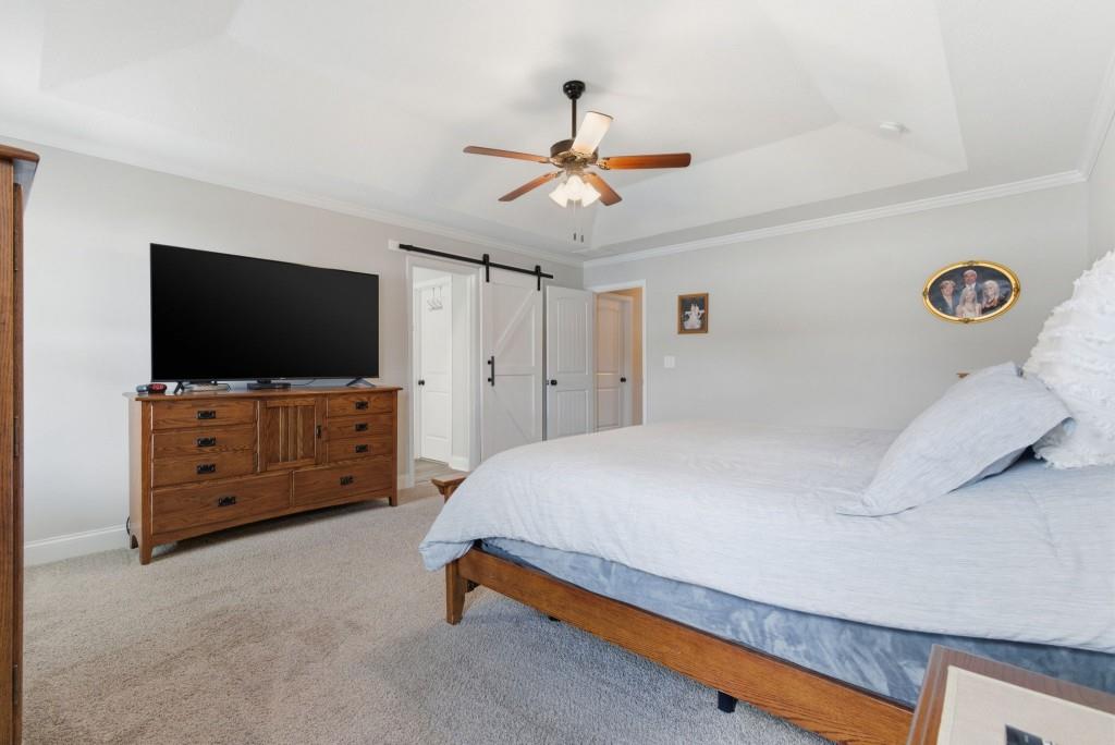 844 River Mist Circle Jefferson, GA 30549 - Photo 26 of 35 a bedroom with a bed and a flat tv screen on dresser