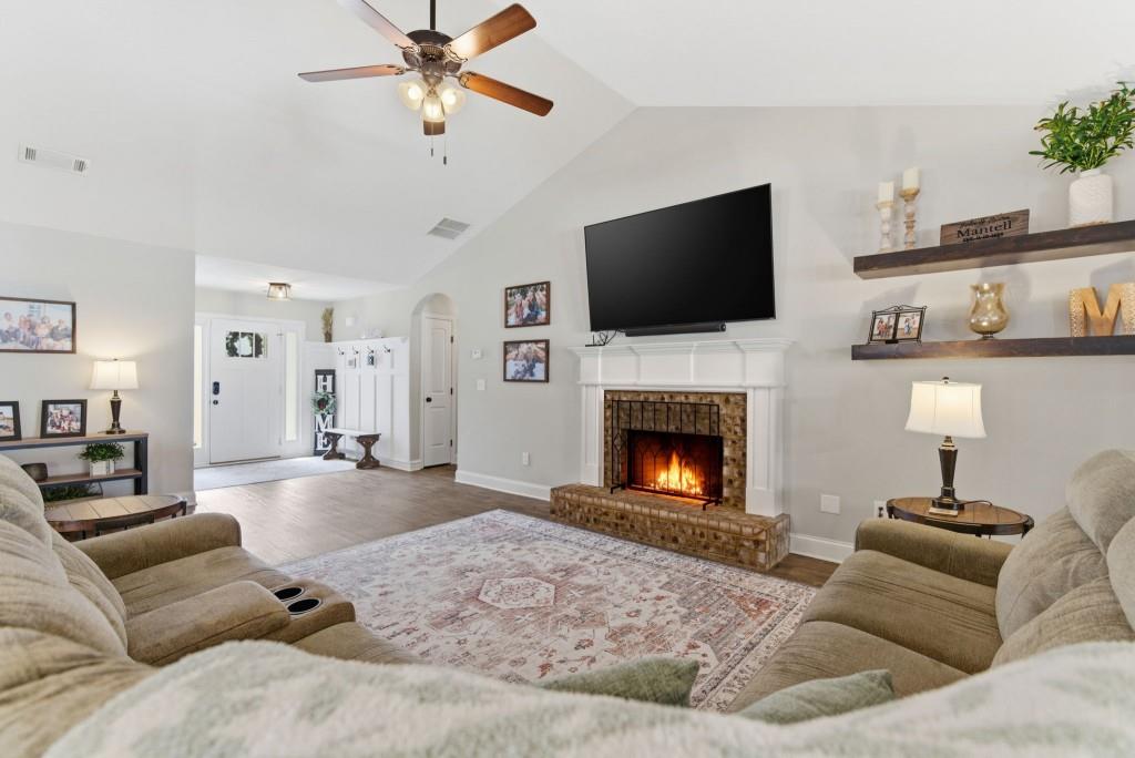 844 River Mist Circle Jefferson, GA 30549 - Photo 9 of 35 a living room with furniture a flat screen tv and a fireplace