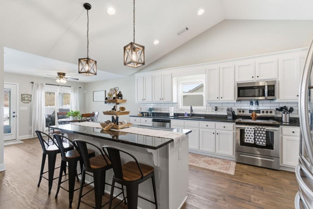 844 River Mist Circle Jefferson, GA 30549 - Photo 10 of 35 a kitchen with a dining table chairs stainless steel appliances and cabinets