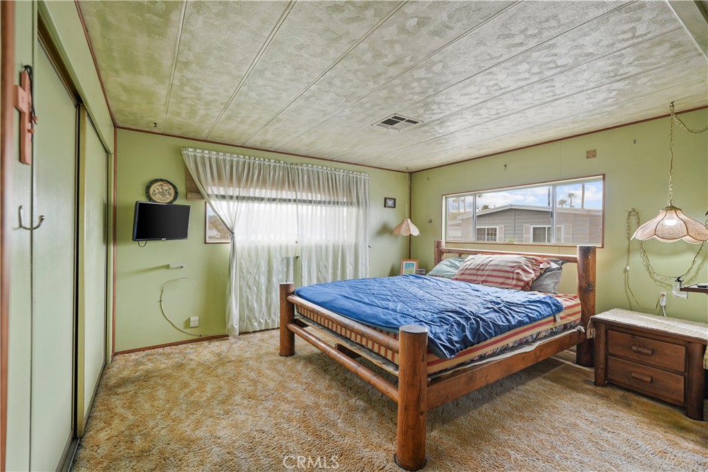 650 South Rancho Santa Fe Road, Unit 106 San Marcos, CA 92078 - Photo 17 of 55 a bedroom with a bed and a chandelier