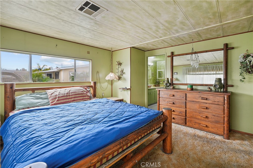 650 South Rancho Santa Fe Road, Unit 106 San Marcos, CA 92078 - Photo 18 of 55 a bedroom with a bed and large windows