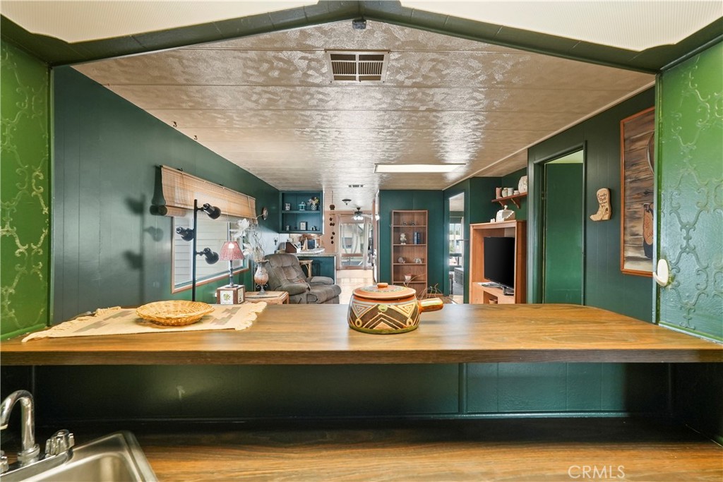 650 South Rancho Santa Fe Road, Unit 106 San Marcos, CA 92078 - Photo 21 of 55 a view of room with kitchen island a table and chairs