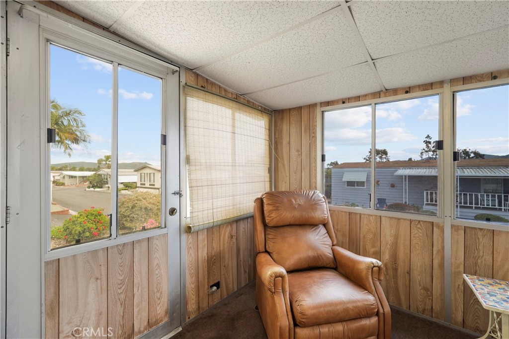 650 South Rancho Santa Fe Road, Unit 106 San Marcos, CA 92078 - Photo 32 of 55 a living room with furniture and a floor to ceiling window