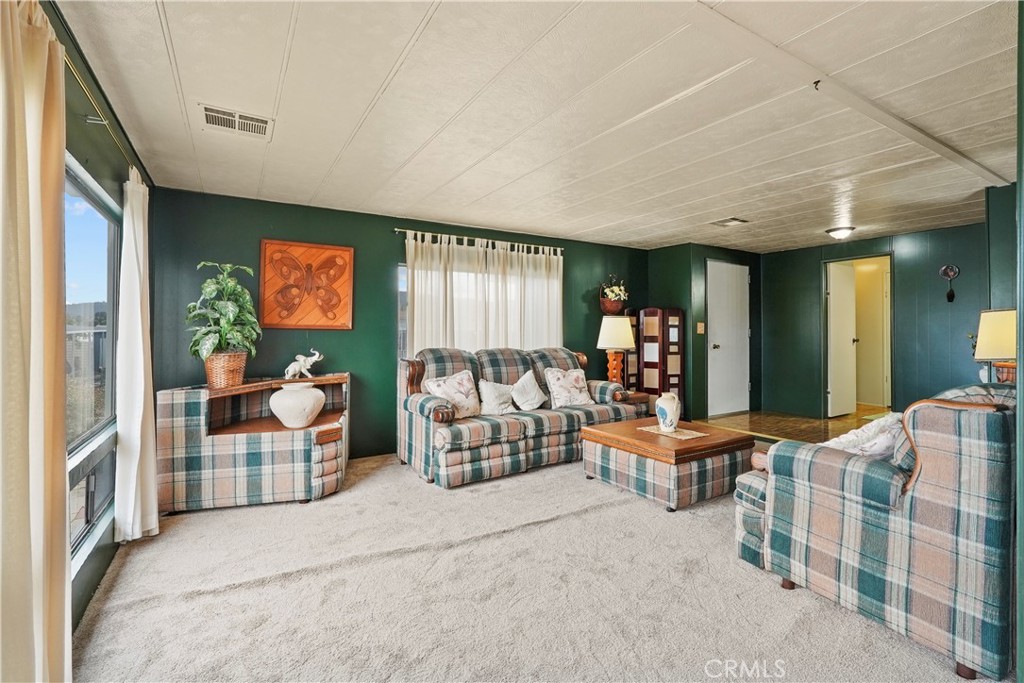 650 South Rancho Santa Fe Road, Unit 106 San Marcos, CA 92078 - Photo 38 of 55 a living room with furniture and a flat screen tv