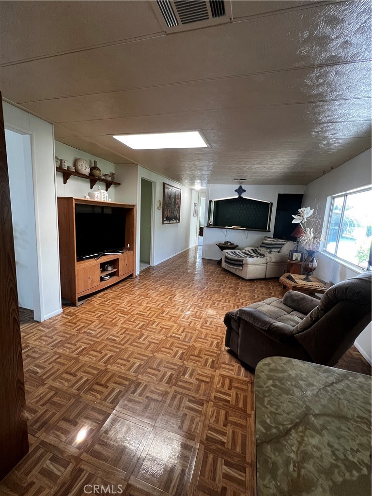 650 South Rancho Santa Fe Road, Unit 106 San Marcos, CA 92078 - Photo 48 of 55 a living room with furniture and a flat screen tv