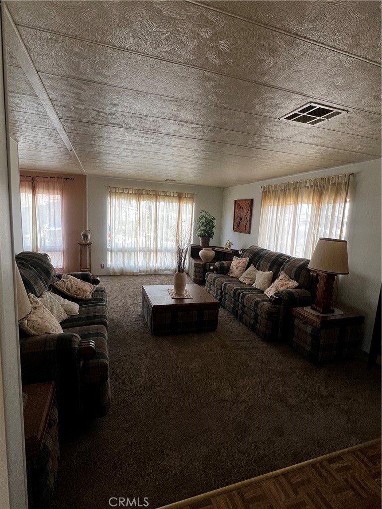 650 South Rancho Santa Fe Road, Unit 106 San Marcos, CA 92078 - Photo 49 of 55 a living room with furniture window and wooden floor