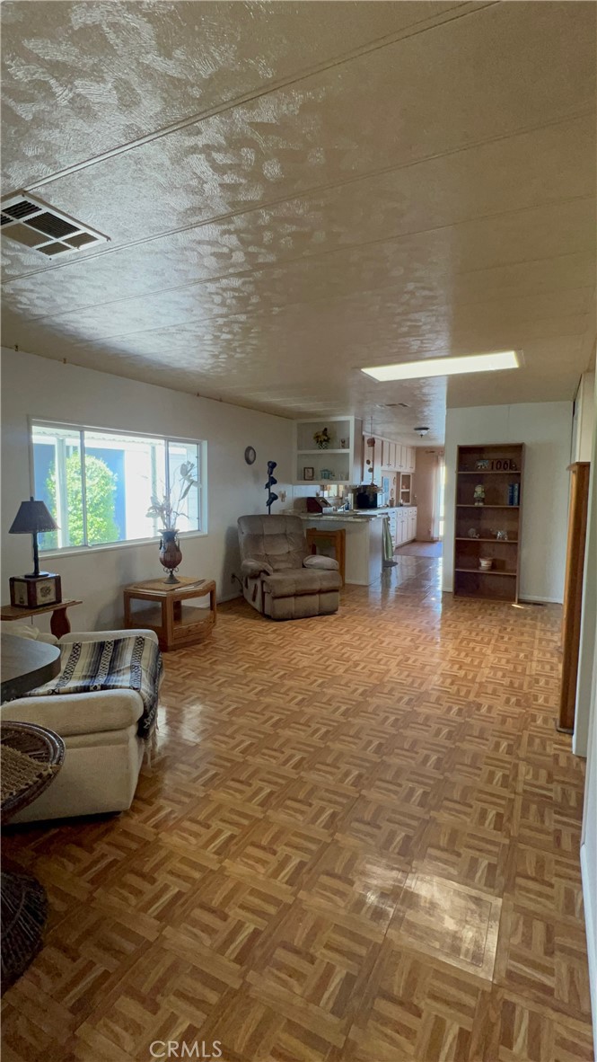 650 South Rancho Santa Fe Road, Unit 106 San Marcos, CA 92078 - Photo 50 of 55 a living room with furniture and a large window