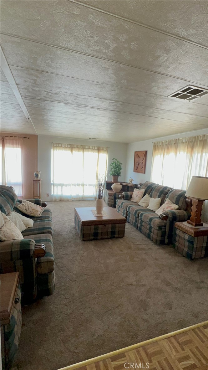 650 South Rancho Santa Fe Road, Unit 106 San Marcos, CA 92078 - Photo 51 of 55 a living room with furniture and a large window